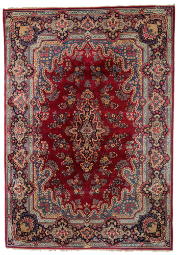 A large Oriental woollen rug, floral decorated,