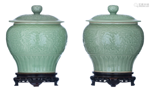 A pair of Chinese celadon glazed 'Lotus' covered jars,