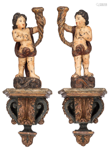 A pair of candelabra, shaped as putti holding the