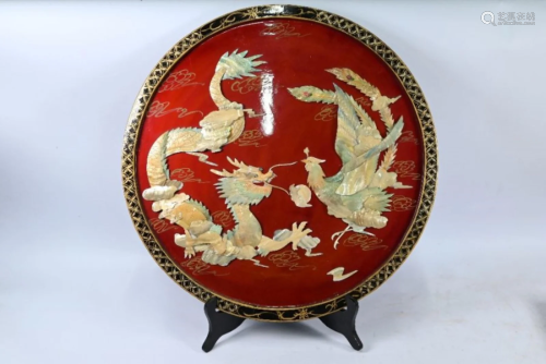 A Chinese red lacquered dragon and phoenix circular