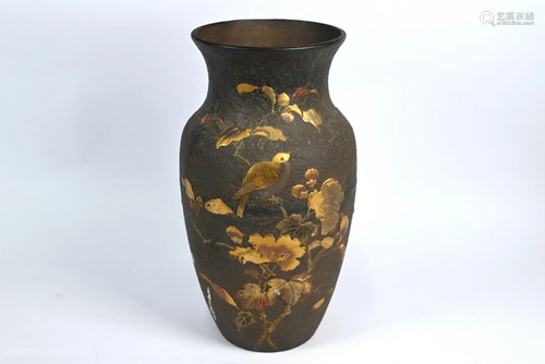 A Japanese cast iron vase decorated with birds and