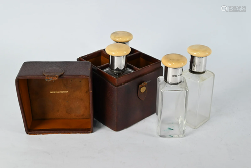 Leather-cased set of four glass spirit flasks