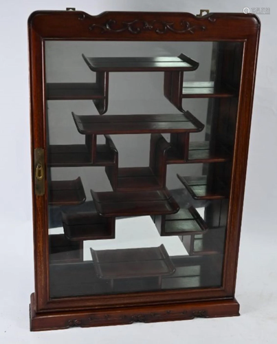 A Chinese hardwood wall hanging display cabinet