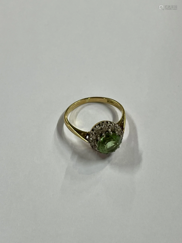 A green tourmaline and diamond circular cluster ring