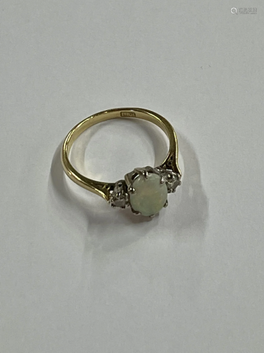A three-stone opal and diamond ring