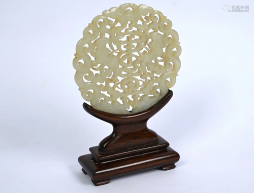 A Chinese pale celadon jade bi-disc on hardwood stand,