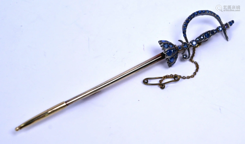 A large sapphire set brooch in the form of a sword