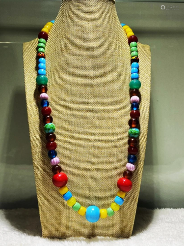 A POLYCHROME GLASS STRING BEAD NECKLACE