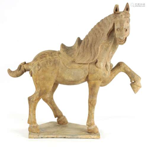 A CHINESE EARTHENWARE MODEL OF A TANG HORSE