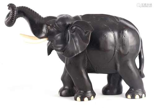 † A LARGE LATE 19TH CENTURY ANGLO-INDIAN CARVED EBONY ELEPHA...