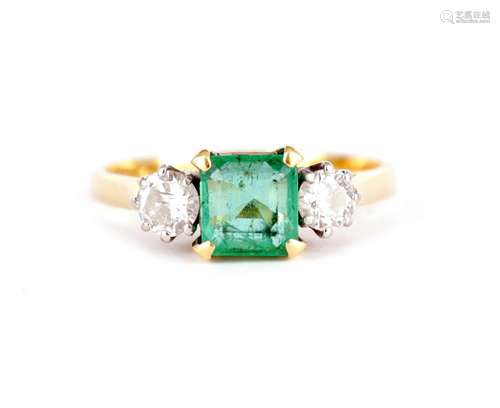 A LADIES 18CT GOLD THREE STONE EMERALD AND DIAMOND RING