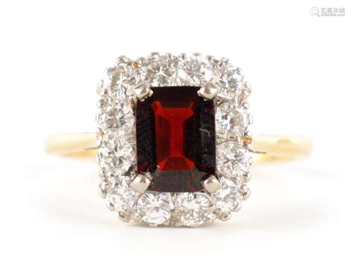 A LADIES 18CT GOLD AND PLATINUM GARNET AND DIAMOND RING