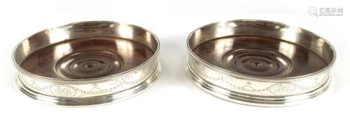 A PAIR OF LATE 18TH CENTURY SILVER BOTTLE COASTERS