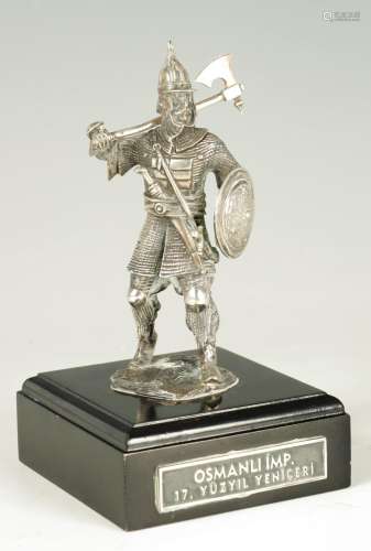 A CAST SILVER FIGURE OF A KNIGHT