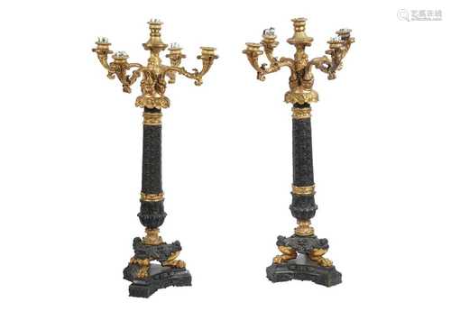 A PAIR OF PATINATED BRONZE AND GILT BRONZE FIVE LIGHT CANDEL...