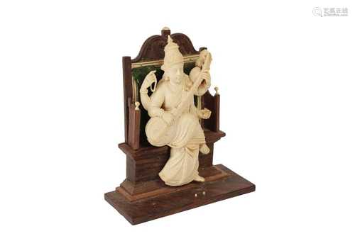 λ AN INDIAN IVORY SCULPTURE OF A FOUR ARMED FEMALE DEITY, LA...