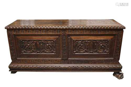 A PROFUSELY CARVED CONTINENTAL CHESTNUT COFFER