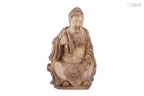 A CHINESE SOAPSTONE FIGURE OF A SEATED OFFICIAL, PROBABLY LA...