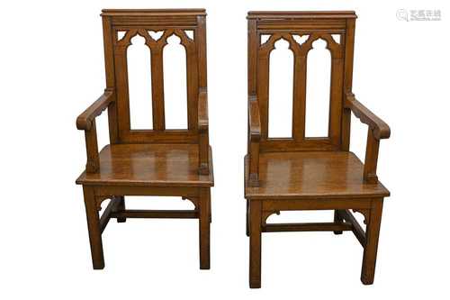 A PAIR OF EARLY 20TH CENTURY ECCLESIASTICAL OAK ARMCHAIRS