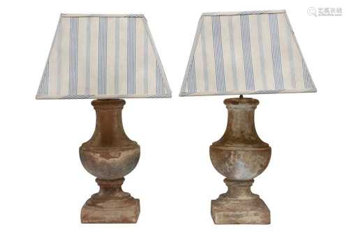 A PAIR OF DISTRESSED TERRACOTTA TABLE LAMPS