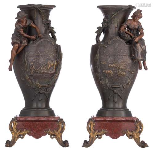 A pair of patinated spelter vases with pastoral scenes, sign...