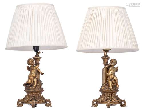 A pair of Napoleon III gilt bronze table lamps, decorated wi...