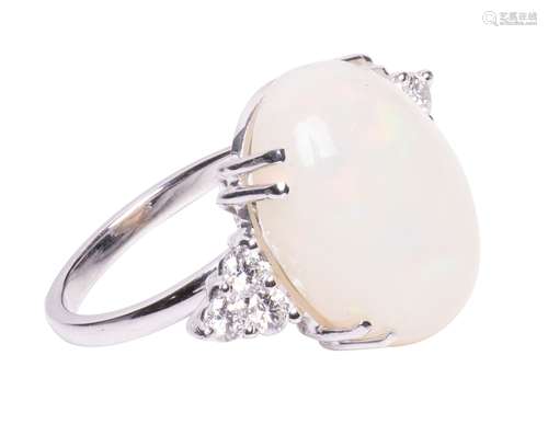 An 18ct white gold ring, central set with an oval opal and b...