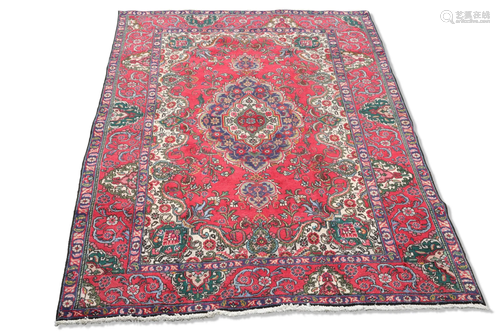 A PERSIAN TABRIZ CARPET, the red ground with