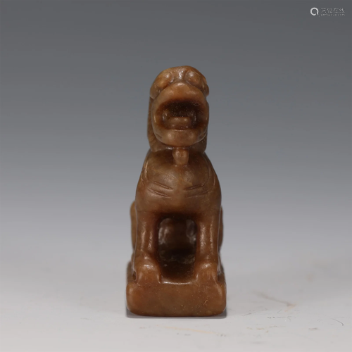 A CARVED RUSSET JADE FOO DOG