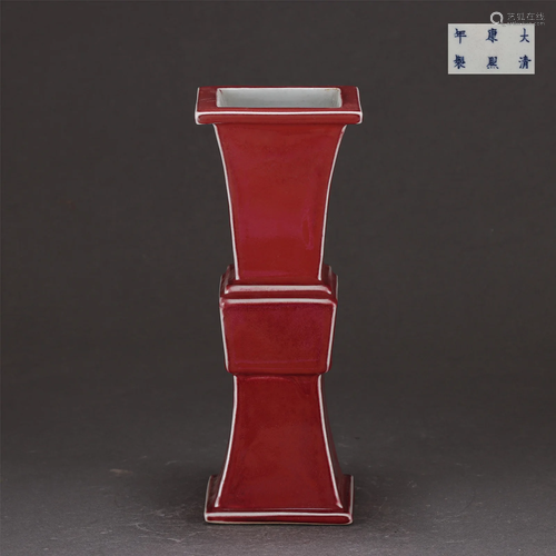 A RED GLAZED BEAKER VASE