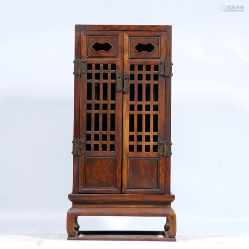 A CARVED HARDWOOD CABINET