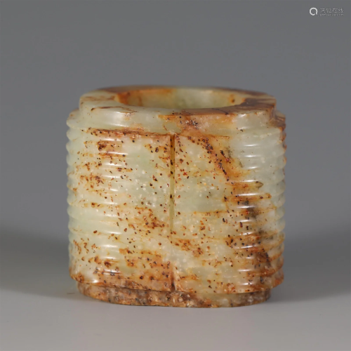 A CARVED WHITE AND RUSSET JADE CONG