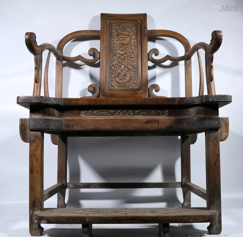 A CARVED HARDWOOD ARMCHAIR