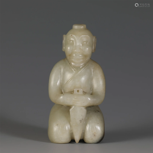 A CARVED WHITE JADE FIGURE