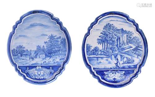 Two similar Dutch Delft blue and white shaped oval wall-plaq...