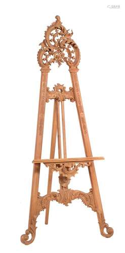 A carved and stripped softwood easel in Rococo taste