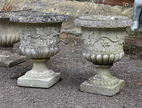 A pair of composition stone urns