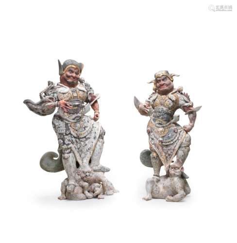 AN IMPRESSIVE PAIR OF PAINTED AND GILT POTTERY FIGURES OF LO...