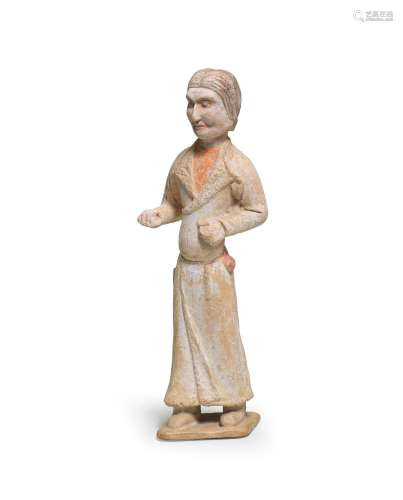 A PAINTED POTTERY FIGURE OF A FOREIGN GROOM