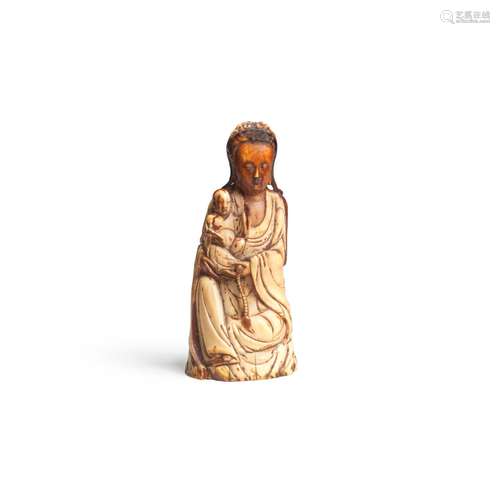 AN IVORY FIGURE OF GUANYIN AND CHILD