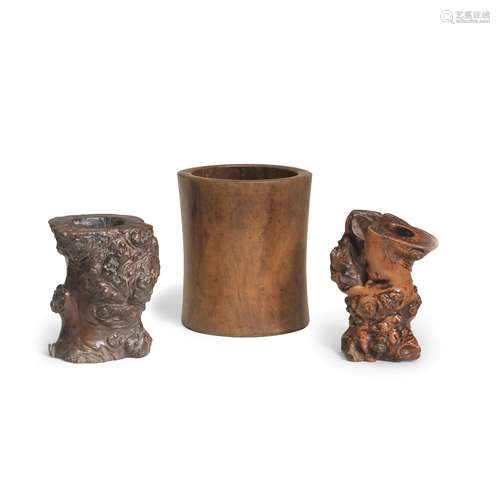 A HUANGHUALI BRUSHPOT AND TWO GNARLED ROOT WOOD BRUSHPOTS, B...