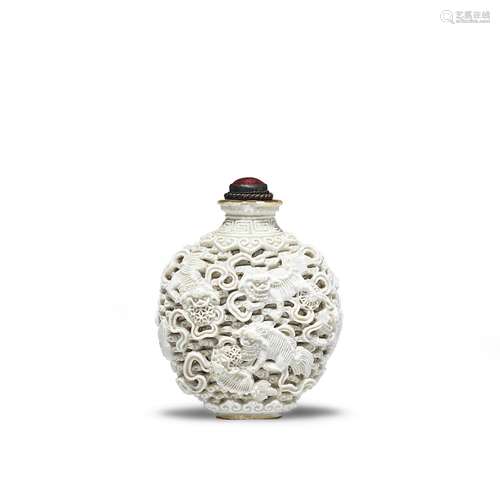 A WHITE-GLAZED 'BUDDHIST LIONS' SNUFF BOTTLE