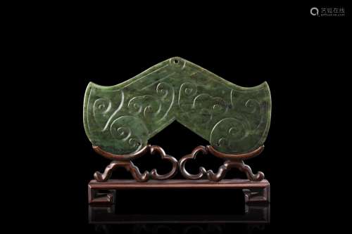 A spinach green jade "sounding stone" pendant, on ...