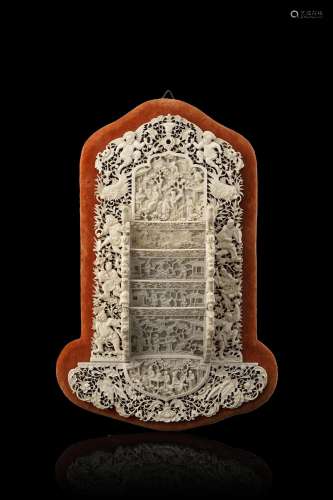 A carved ivory cards holder, on velvet panel (slight defects...