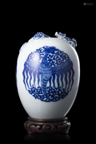 A blue and white porcelain vase, with dragon and bat relief,...