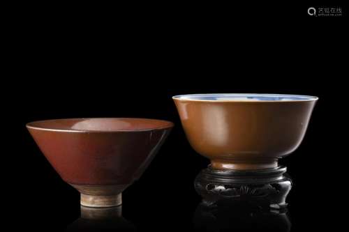 A red glaze bowl and a brown glaze bowl, one with wood stand...