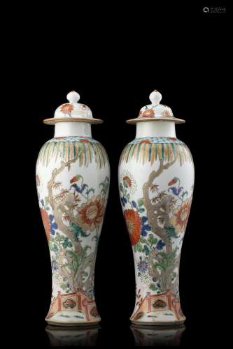 A pair of famille verte slender baluster vases and covers, e...