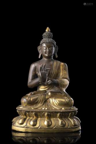 A part gilt bronze Sakyamuni Buddha, seated on a double lotu...