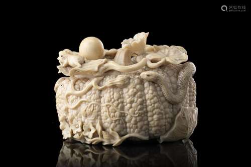 An ivory box shaped as a pumpkin with a snake and a frog, th...