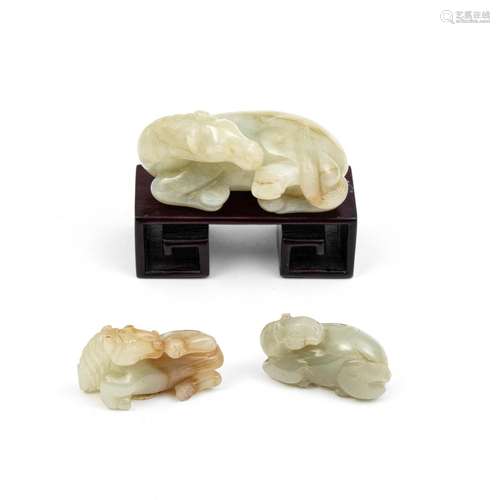 THREE PALE GREEN JADE RECUMBENT HORSES